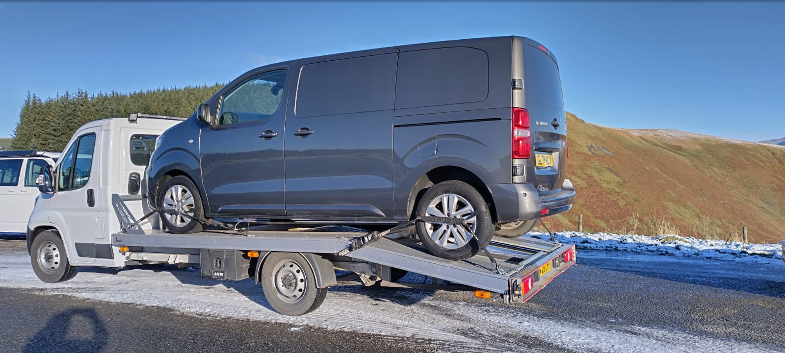 Britannia Vehicle Delivery van on a snowy mountain road